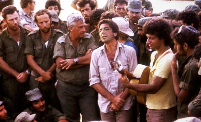 Leonard Cohen performing for the IDF, with Ariel Sharon looking on.